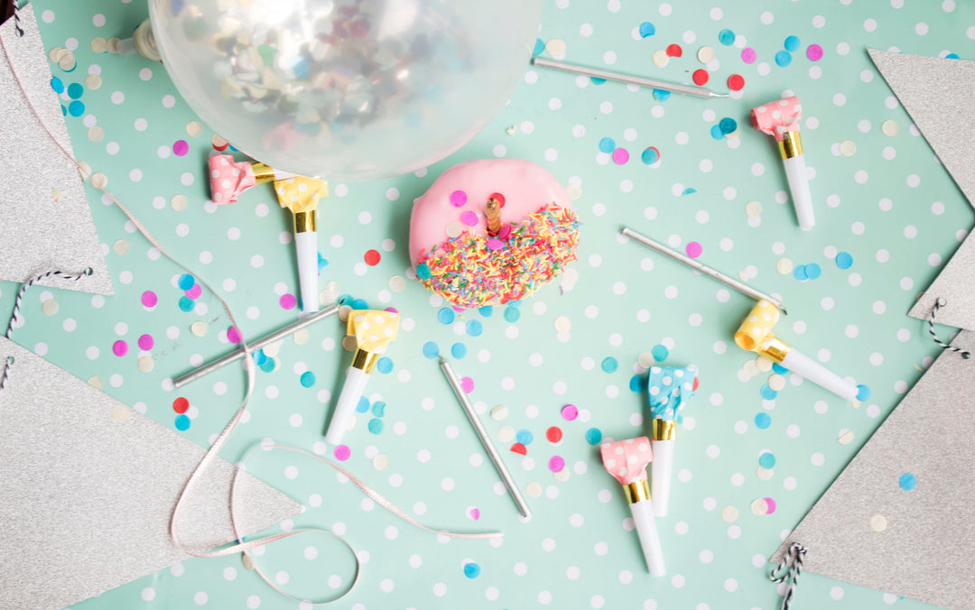 Party table scene with balloon, done and confetti