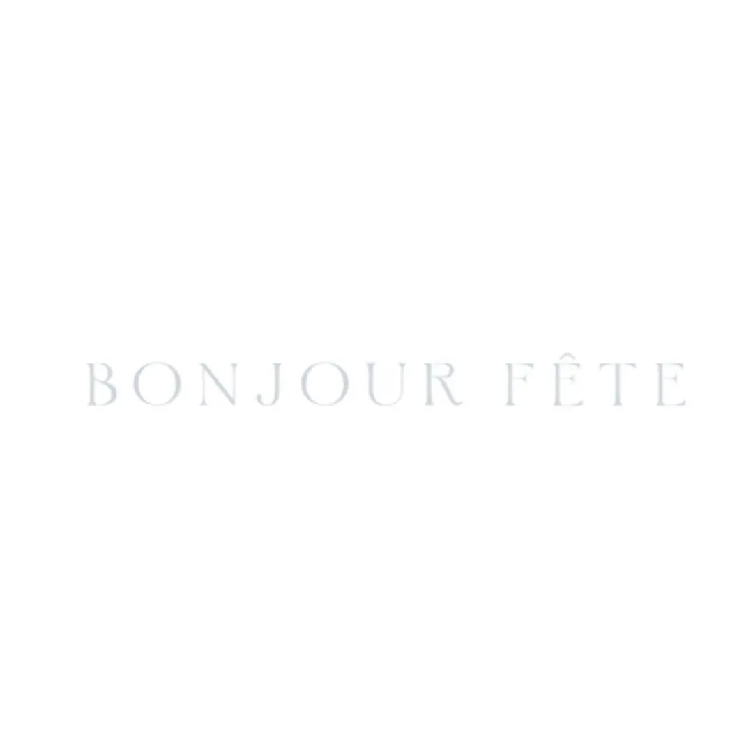 Faded pale grey Bonjour Fête wordmark on a white background