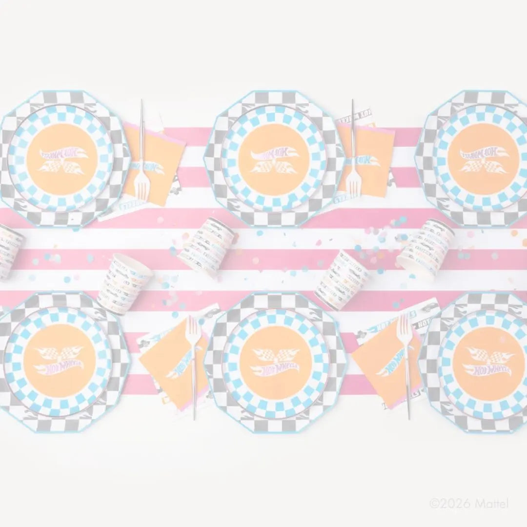 Faded overhead Hot Wheels party table with checkerboard plates, cups and orange napkins on pink stripes