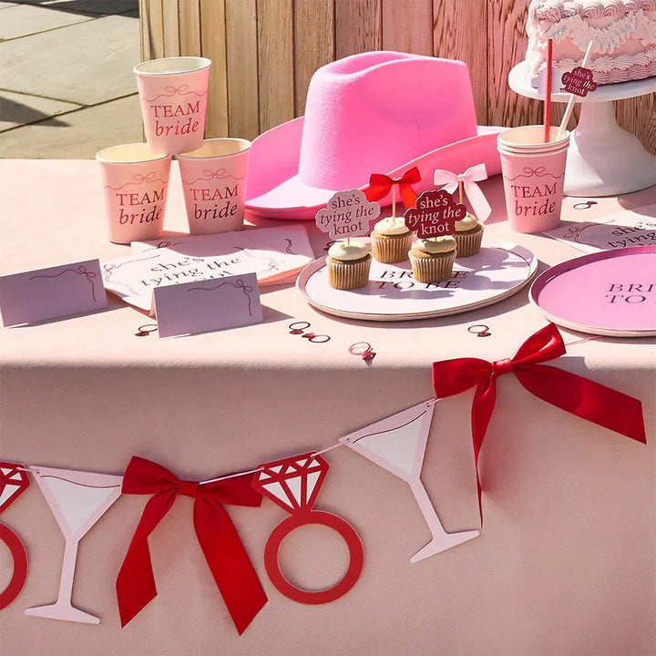 Pink & Red Hen Party Garland - She’s Tying The Knot Bow Bunting - Coquette Hen Do Backdrop with Cocktails, Rings And Satin Bows - 2m - Jolie Fete UK