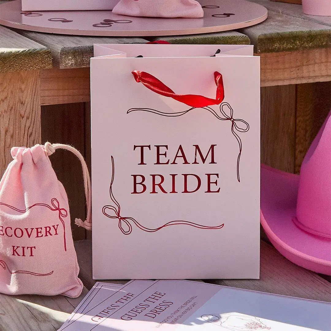 Team Bride Party Bags - Pink & Red She’s Tying The Knot Hen Do Gifts - Coquette Hen Party Gift Bags with Red Satin Handles - Pack of 5 - Jolie Fete UK