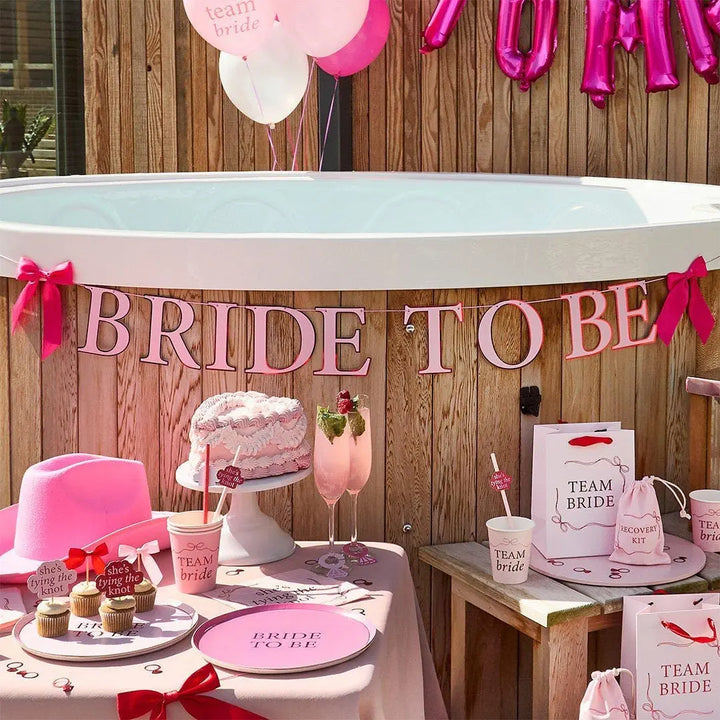 Team Bride Party Bags - Pink & Red She’s Tying The Knot Hen Do Gifts - Coquette Hen Party Gift Bags with Red Satin Handles - Pack of 5 - Jolie Fete UK
